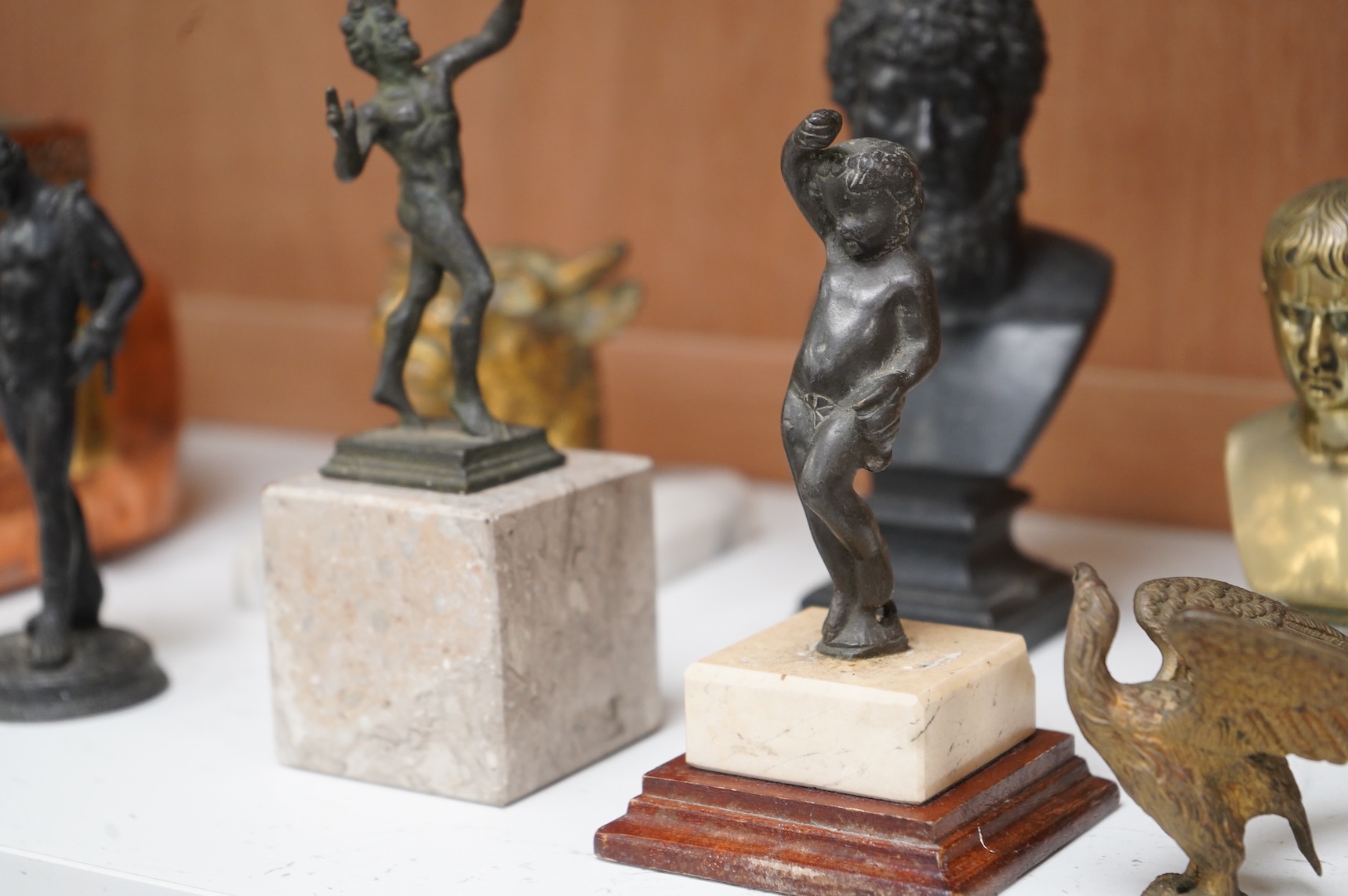 Italian grand tour souvenirs, 19th/20th century; nine small sculptures and busts, after the antique, the majority bronze and one depicting Lucius Verus, largest 19cm high
